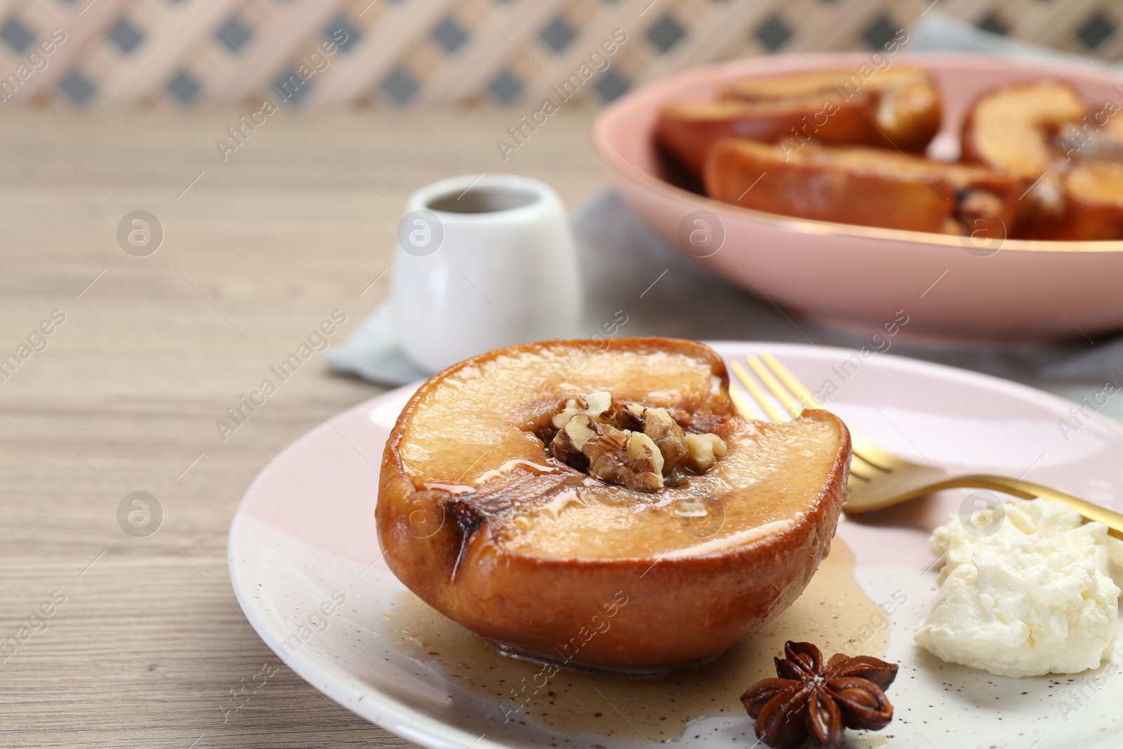 Photo of Delicious quince baked with honey and walnuts on wooden table