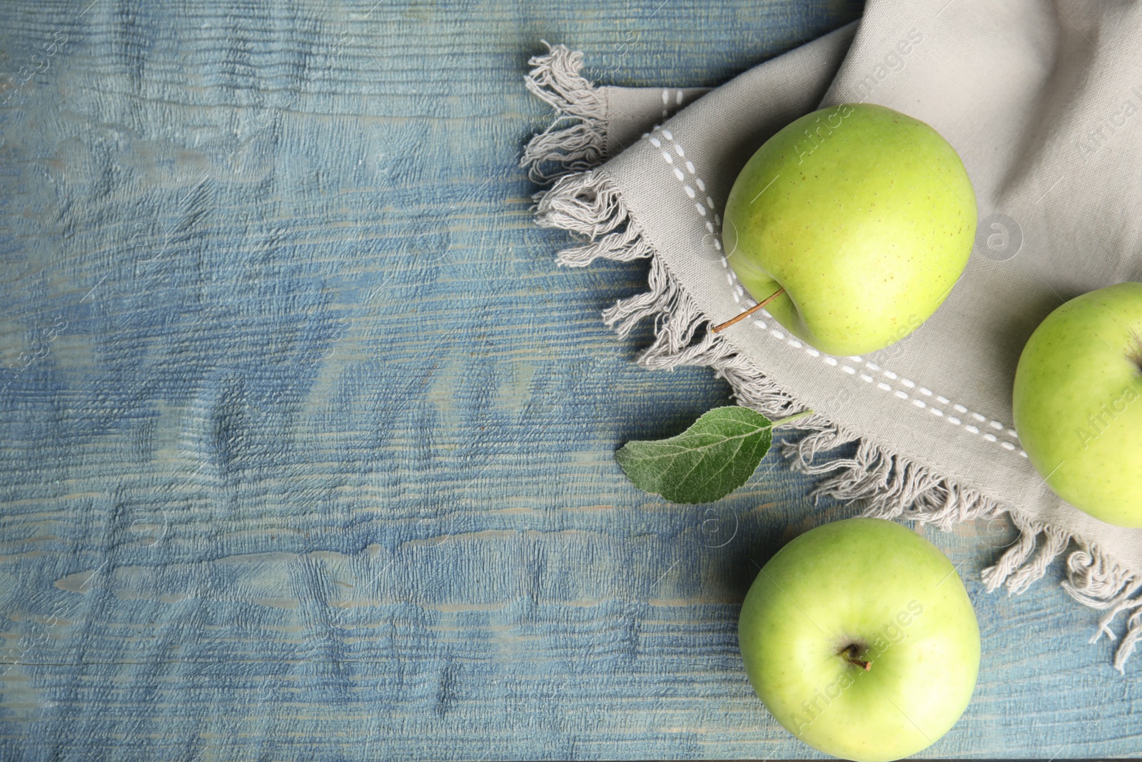 Photo of Flat lay composition of fresh ripe green apples on wooden table, space for text