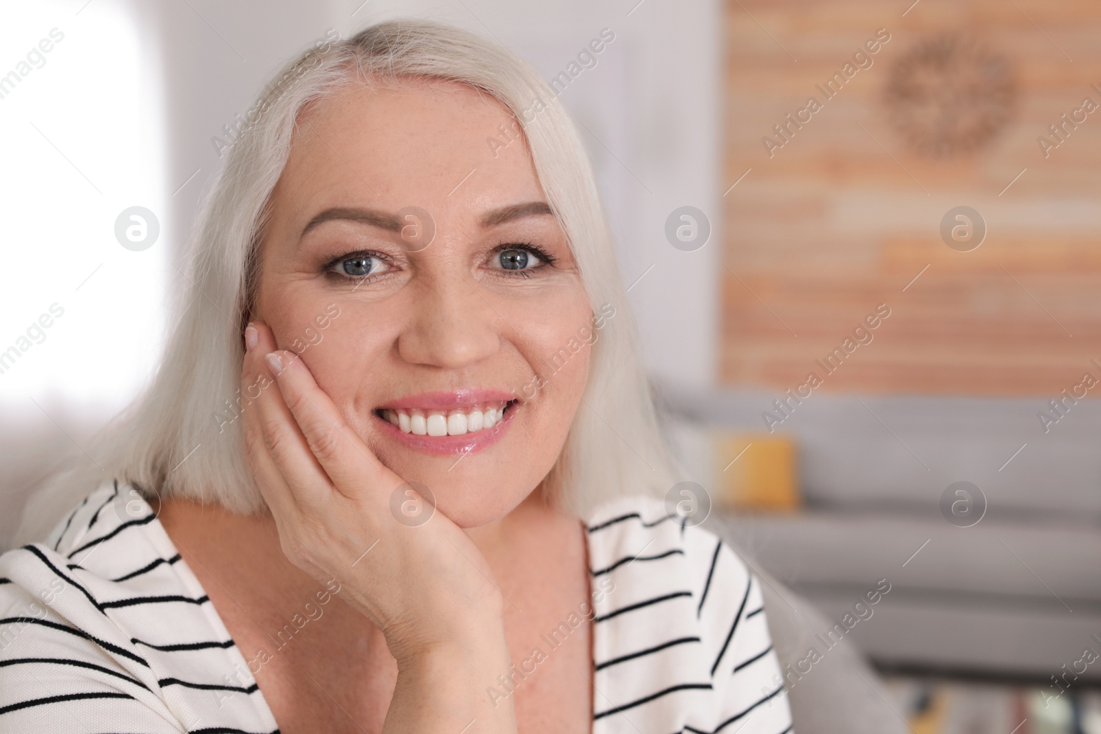 Photo of Portrait of mature woman in living room