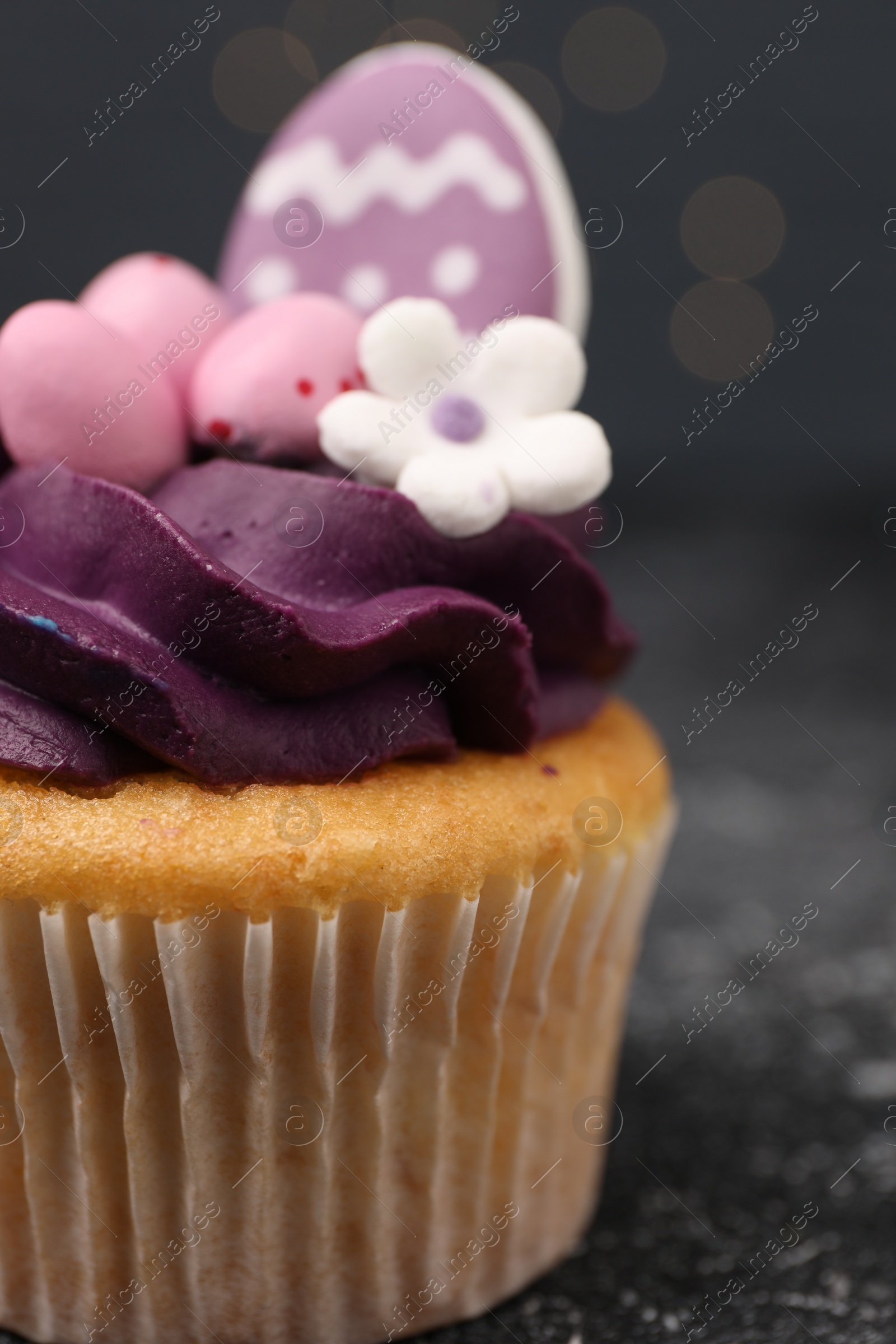 Photo of Tasty decorated Easter cupcake on grey table, closeup