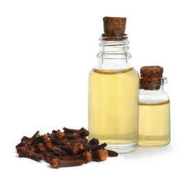 Photo of Essential oil and dried cloves on white background