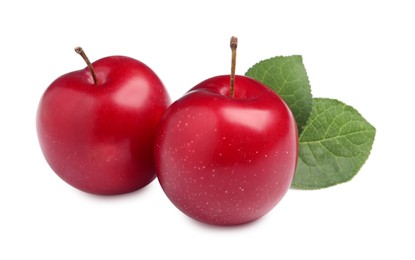 Delicious ripe cherry plums with leaves on white background