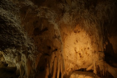 Many stalactite and stalagmite formations inside cave