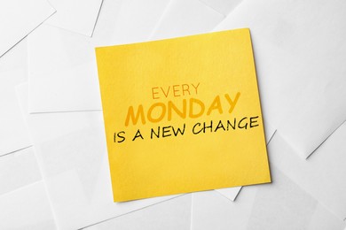 Image of Note with motivational quote Every Monday Is A New Change on paper sheets, top view