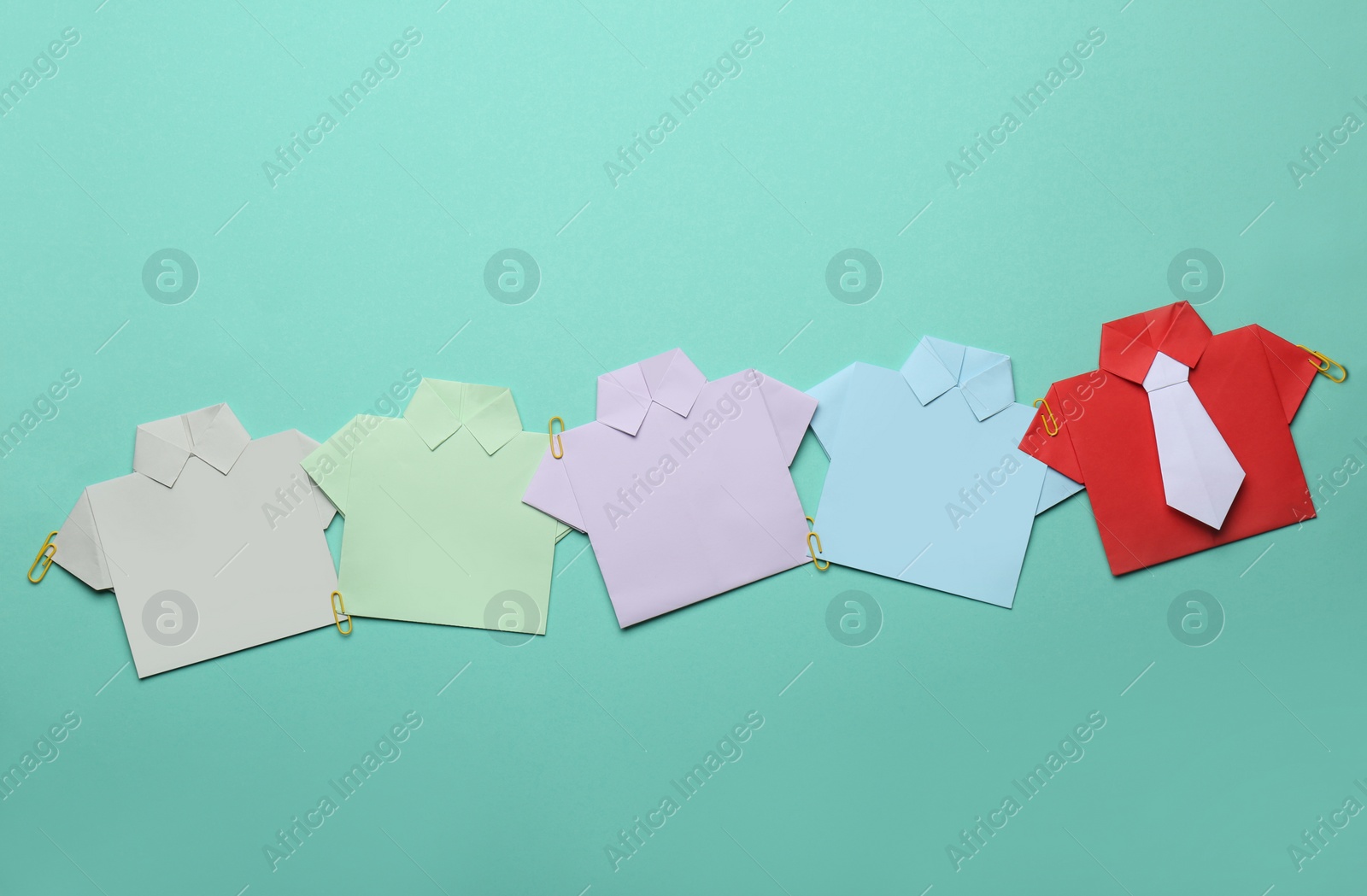 Photo of Many paper shirts on turquoise background, flat lay with space for text. Recruiter searching employee
