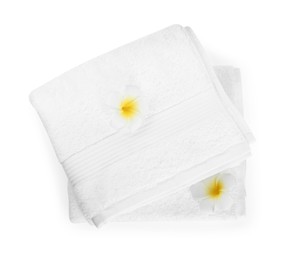 Photo of Terry towels and plumeria flowers isolated on white, top view