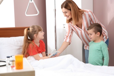 Photo of Happy family visiting little child in hospital