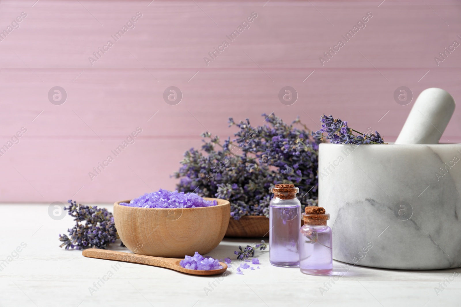 Photo of Composition with natural cosmetic products and lavender flowers on wooden table against pink background