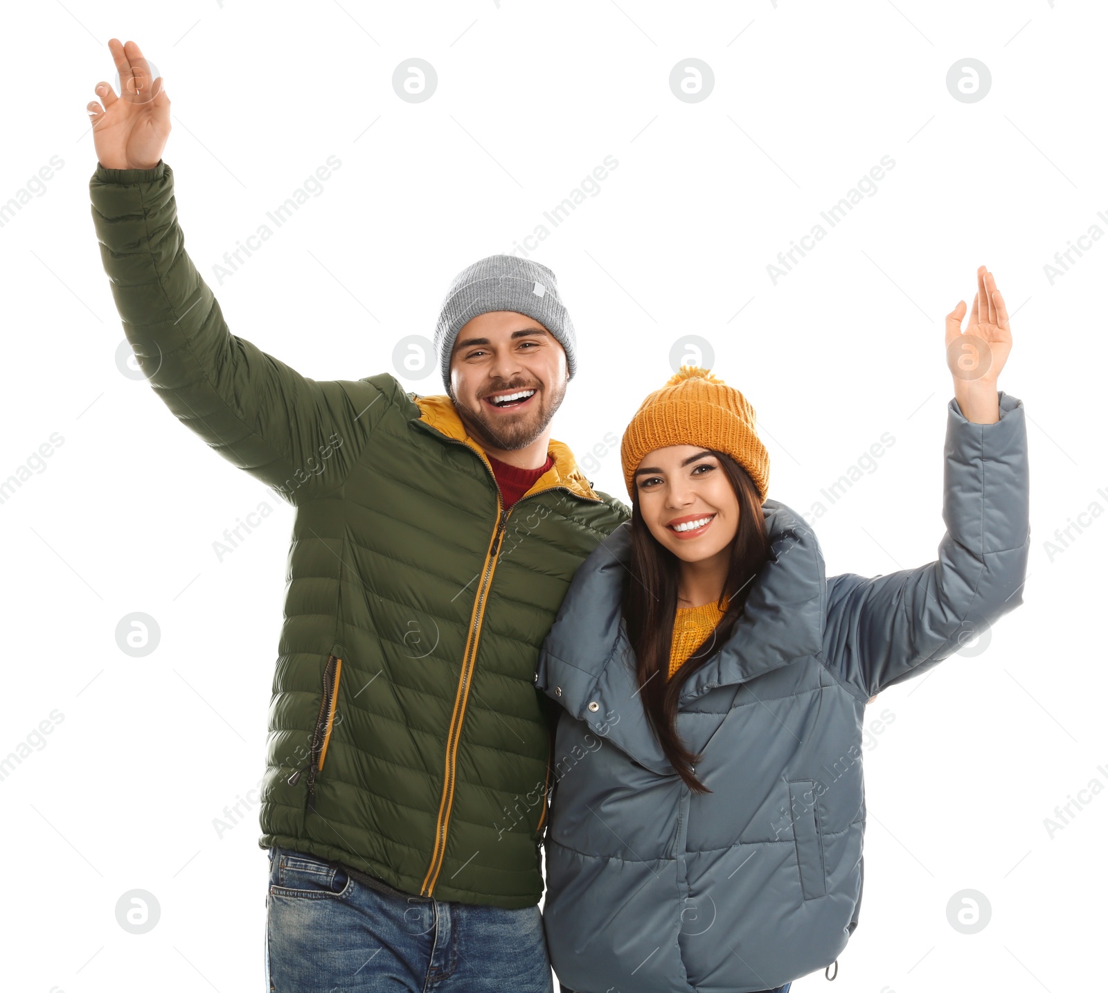 Photo of Happy young couple in warm clothes on white background. Winter vacation