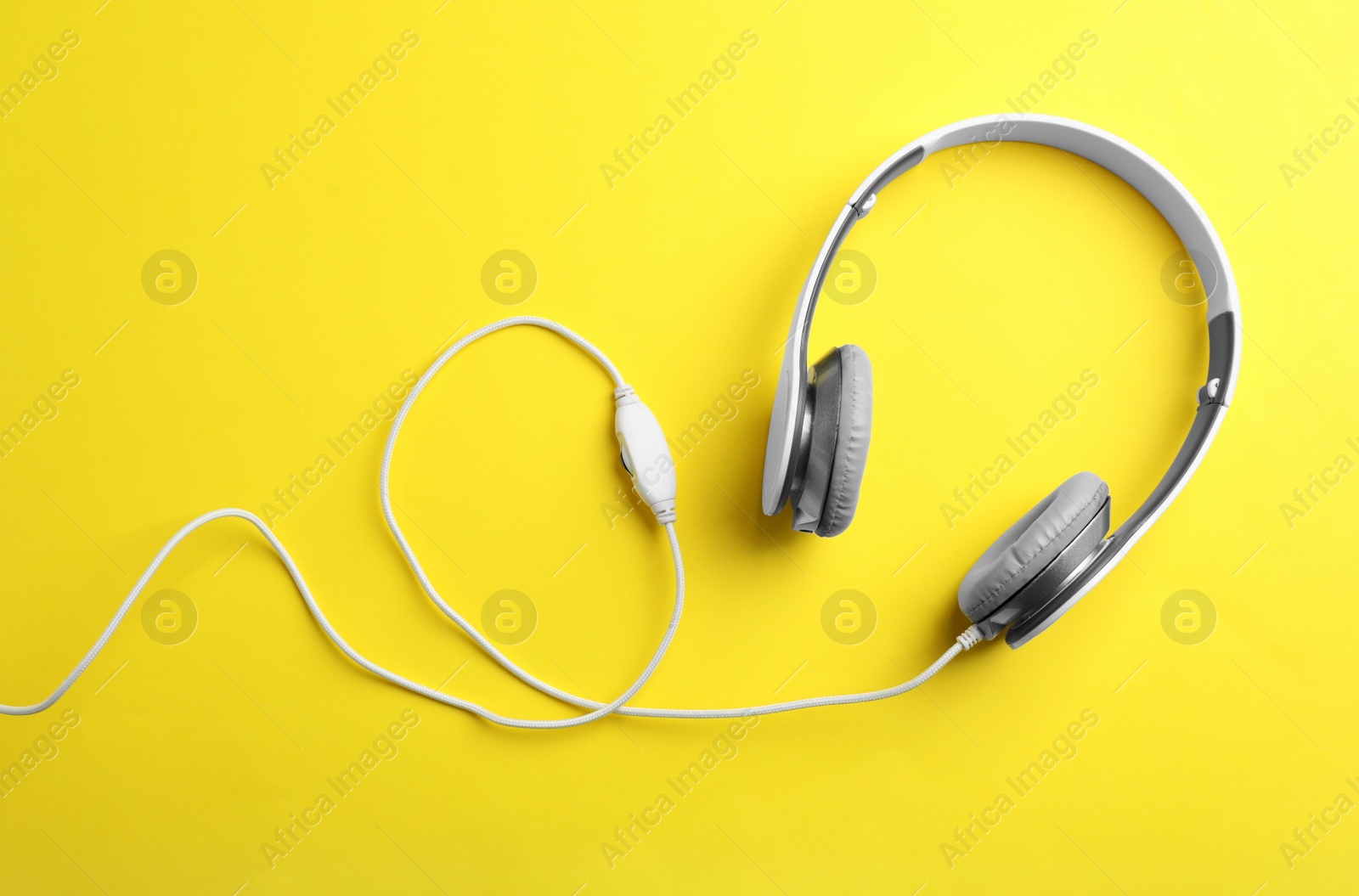 Photo of Stylish headphones on color background, top view