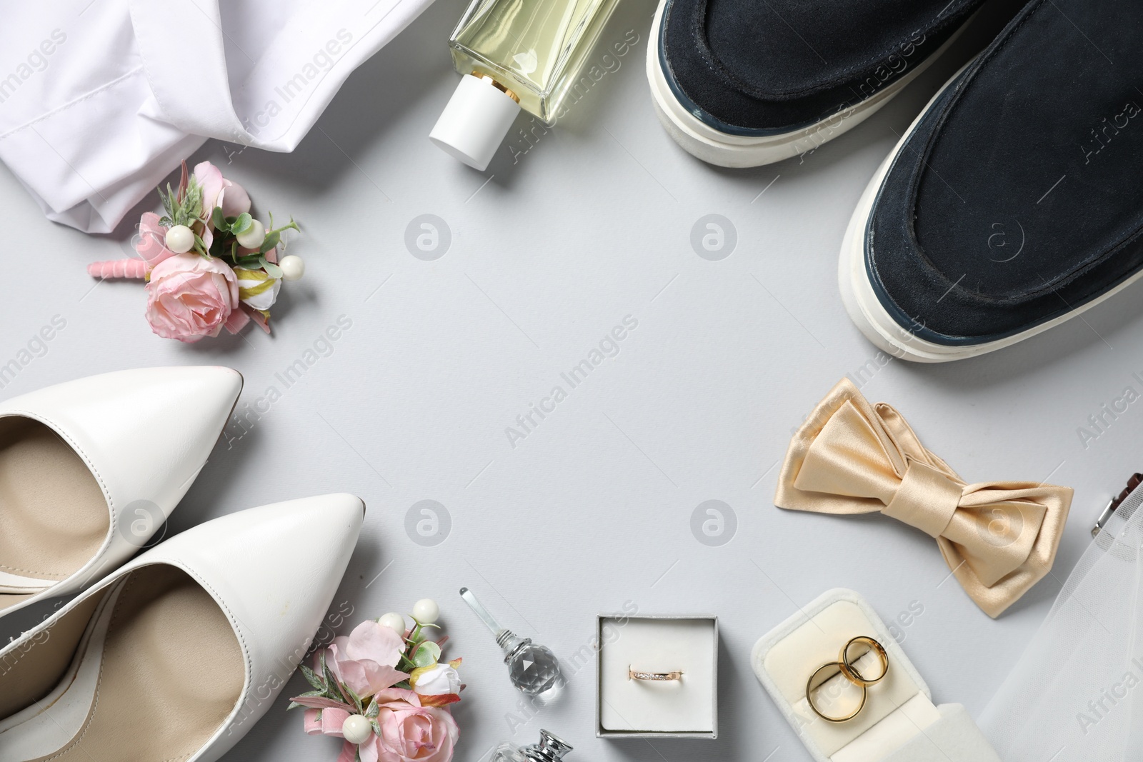 Photo of Wedding stuff. Flat lay composition with stylish boutonniere on light gray background, space for text