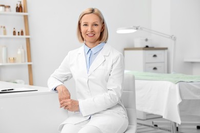 Portrait of happy dermatologist in modern clinic