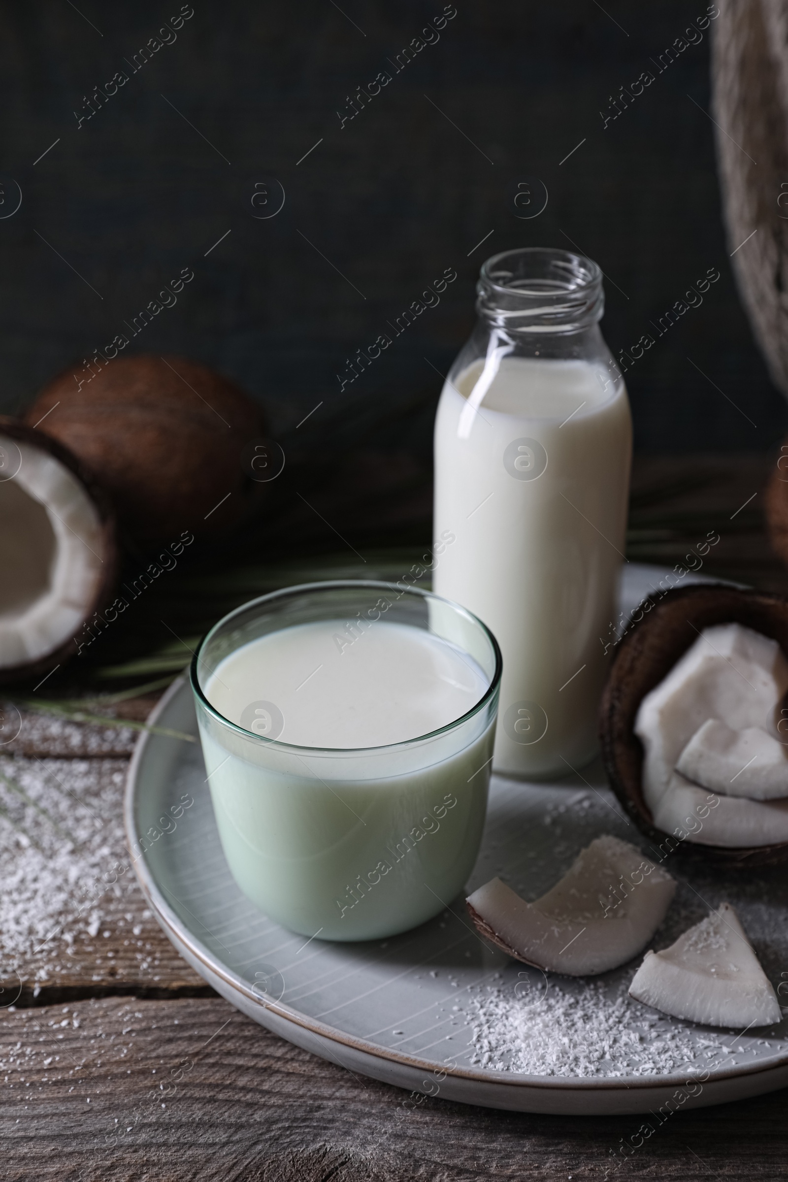 Photo of Composition with coconut milk on wooden table