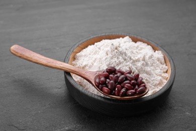 Photo of Kidney bean flour and seeds on black table