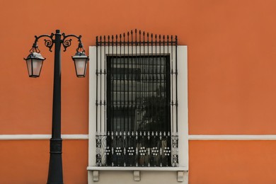 Photo of Exterior of building with beautiful window and steel grilles