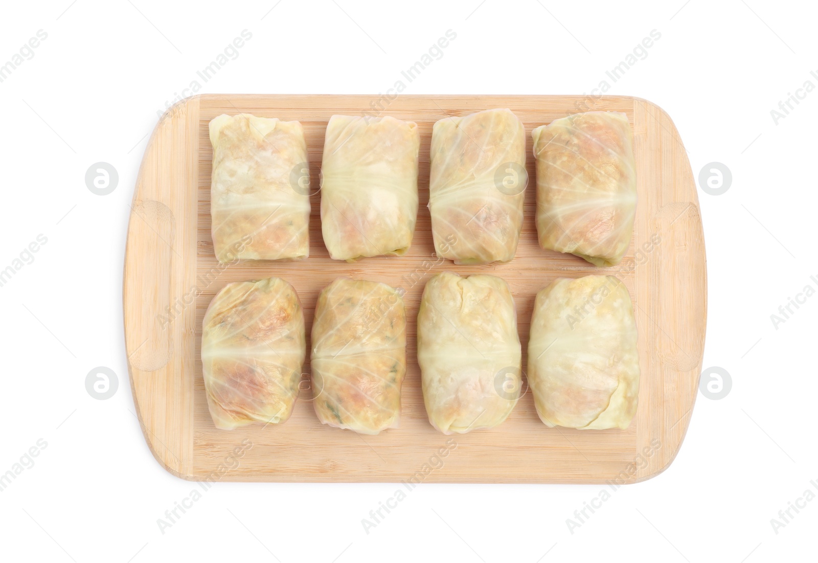 Photo of Wooden board with uncooked stuffed cabbage rolls on white background, top view