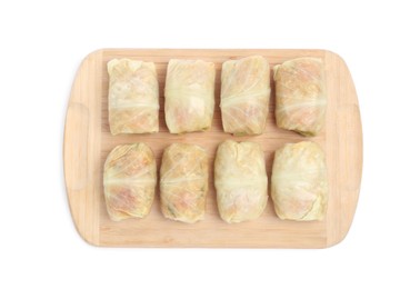 Photo of Wooden board with uncooked stuffed cabbage rolls on white background, top view