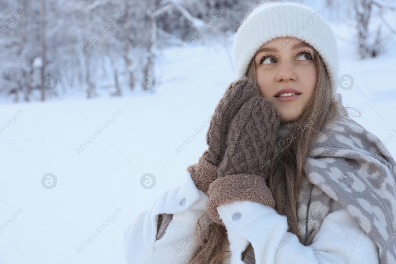 Photo of Winter vacation. Beautiful woman near snowy forest outdoors. Space for text