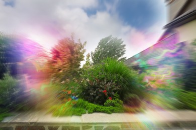 Image of View of garden near house and flashing lights effect. Migraine aura, symptom of disease