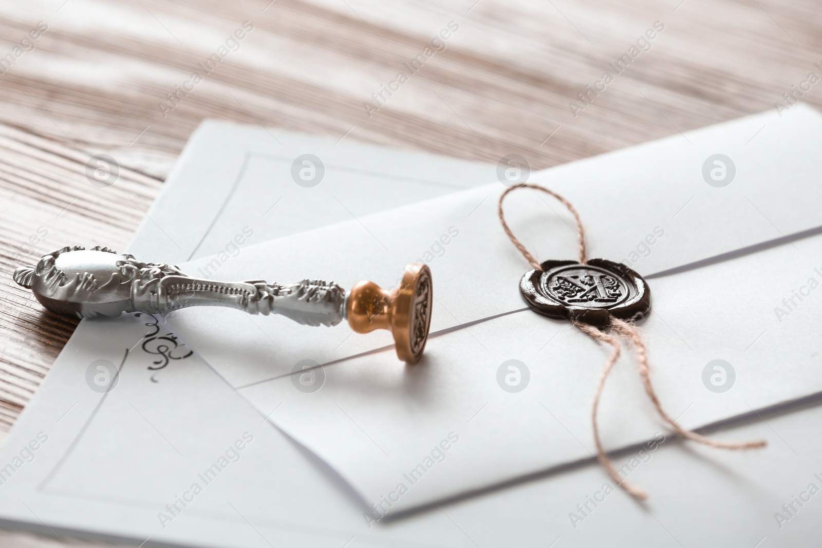 Photo of Vintage notary stamp and documents on wooden table, closeup