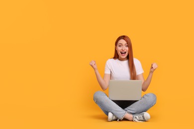 Photo of Happy young woman with laptop on yellow background, space for text