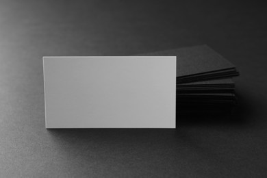 Photo of Blank business cards on black background, closeup. Mockup for design