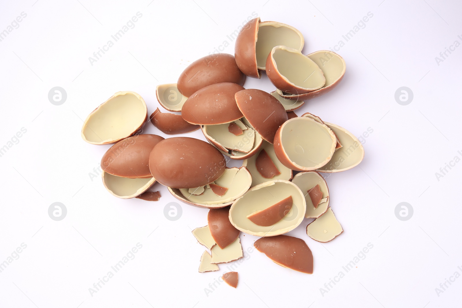 Photo of Sveti Vlas, Bulgaria - July 3, 2023: Broken halves of Kinder Surprise Eggs isolated on white, top view