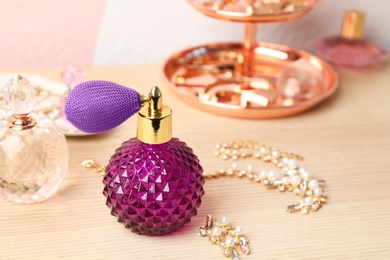 Photo of Perfume bottles and jewellery on dressing table