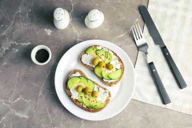 Photo of Tasty breakfast with crisp avocado  toasts on table, top view