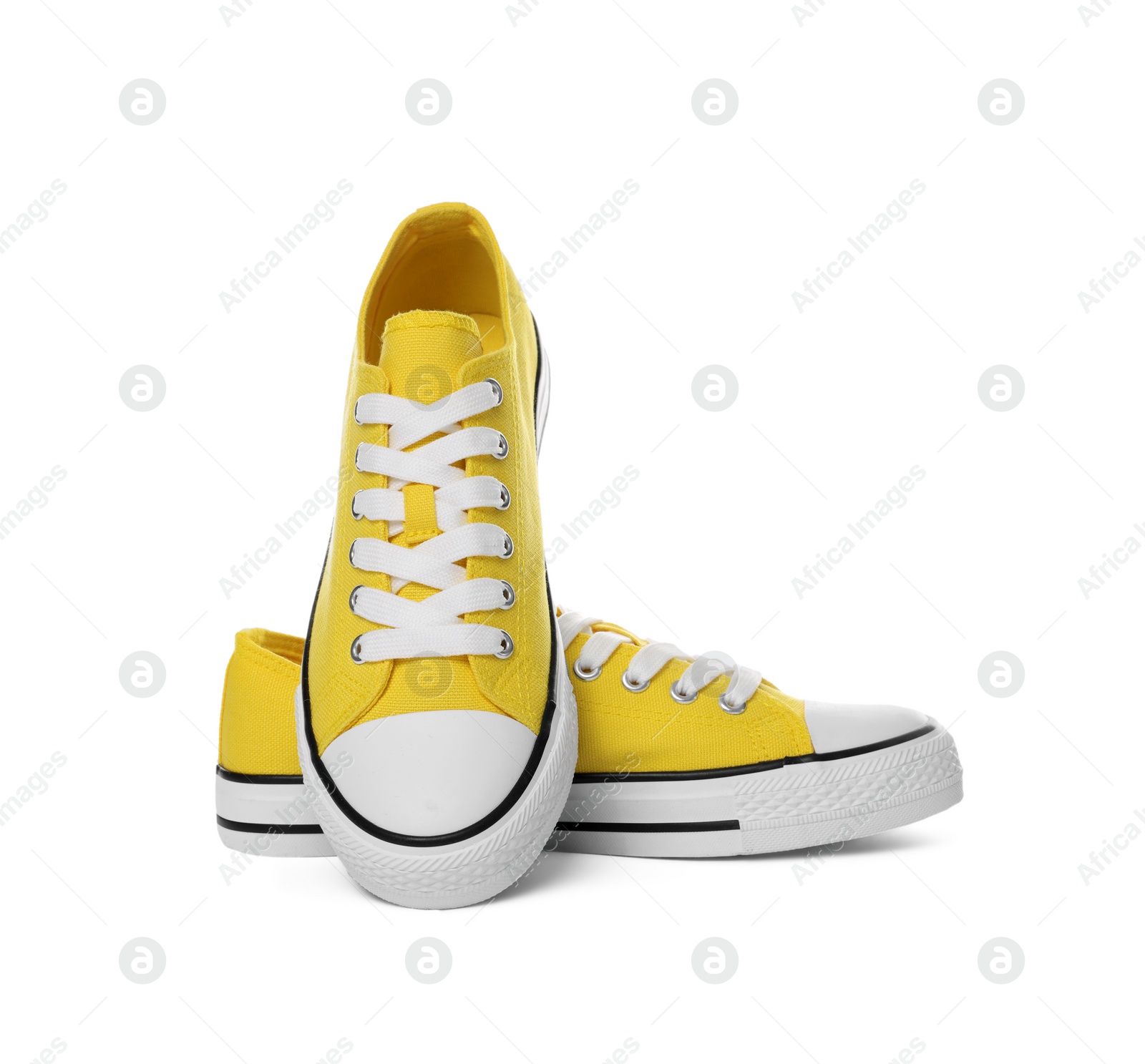 Photo of Pair of yellow classic old school sneakers on white background