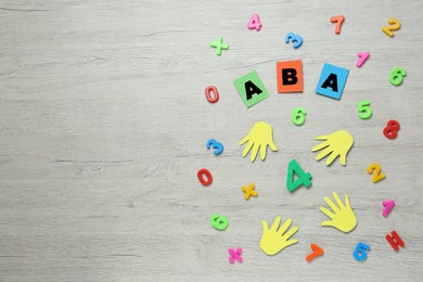 Photo of Flat lay composition with abbreviation ABA (Applied behavior analysis) and colorful numbers on white wooden table, space for text