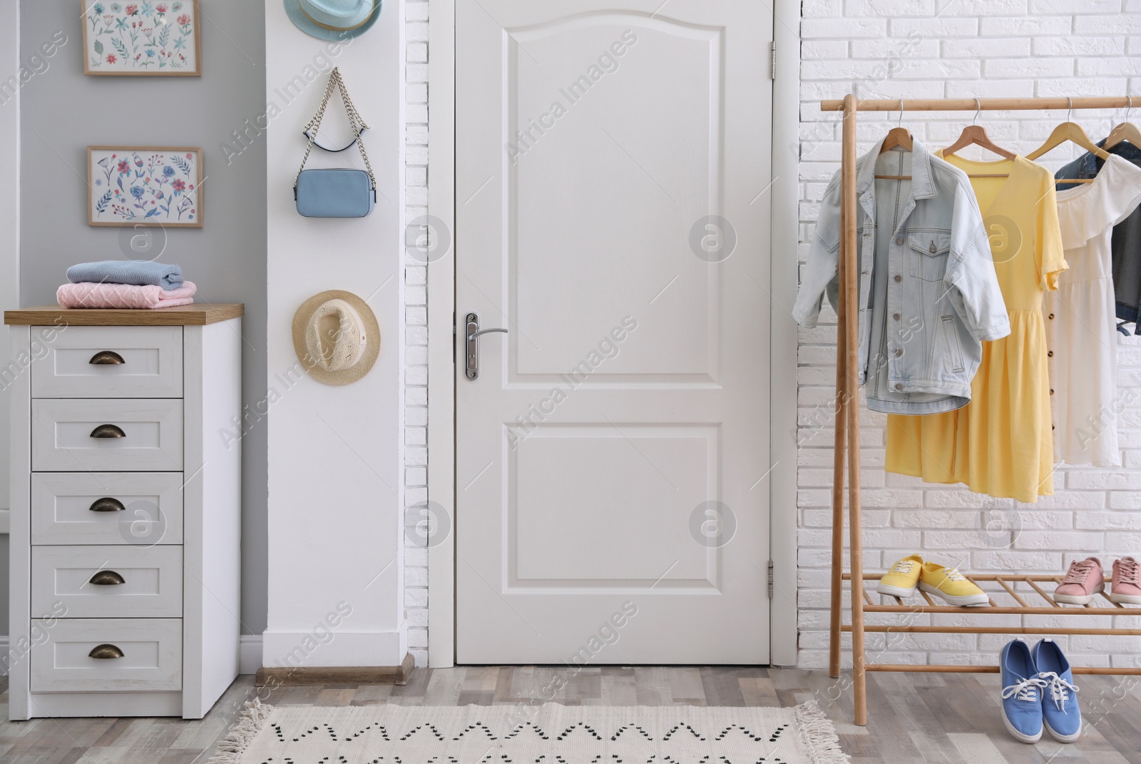 Photo of Hallway interior with stylish furniture, clothes and accessories