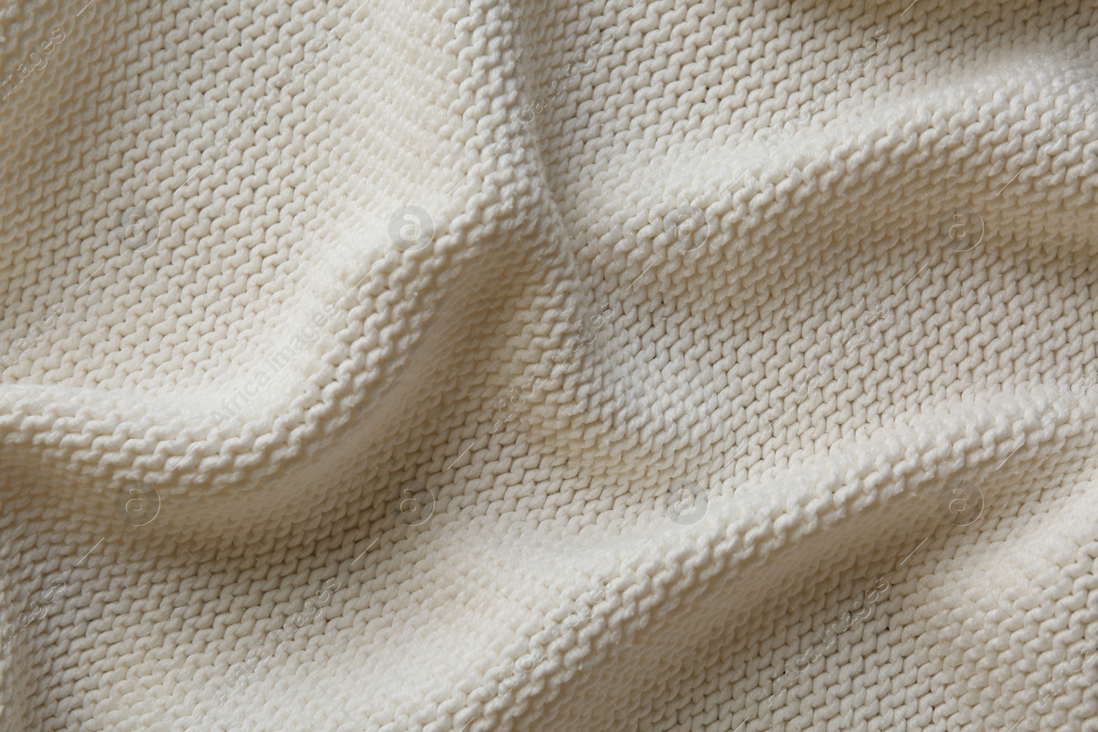 Photo of Beautiful white knitted fabric as background, top view