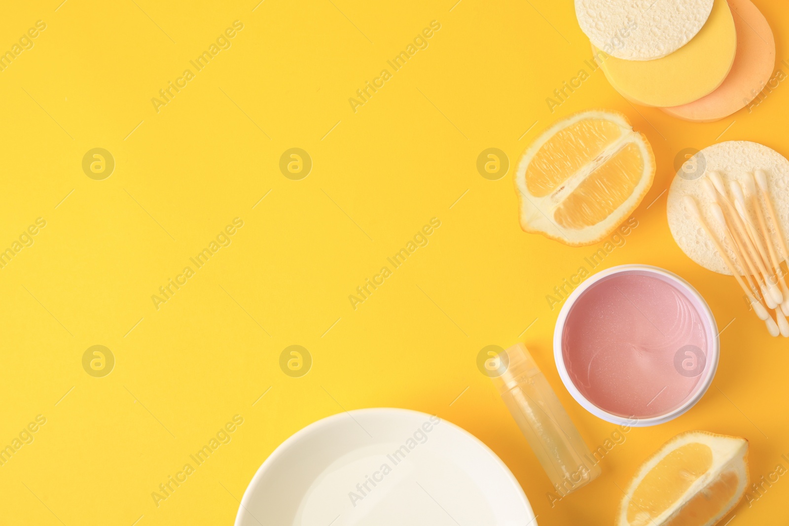 Photo of Lemon face cleanser. Fresh citrus fruits and personal care products on yellow background, flat lay with space for text