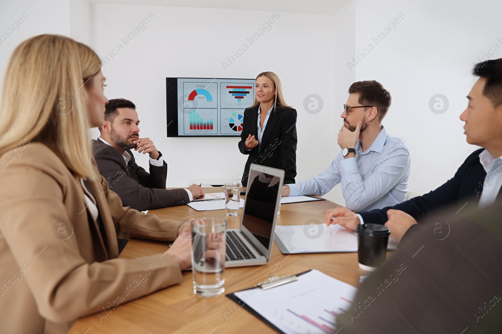 Photo of Businesswoman having meeting with her employees in office