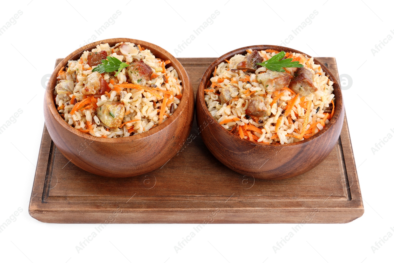 Photo of Delicious pilaf with meat and carrot in bowls isolated on white