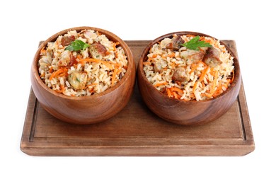 Photo of Delicious pilaf with meat and carrot in bowls isolated on white