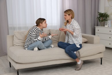 Photo of Mother and her teenage daughter having argument at home