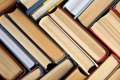 Photo of Many different hardcover books as background, top view