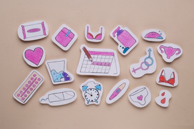 Photo of Woman`s health. Different paper figures on beige background, flat lay