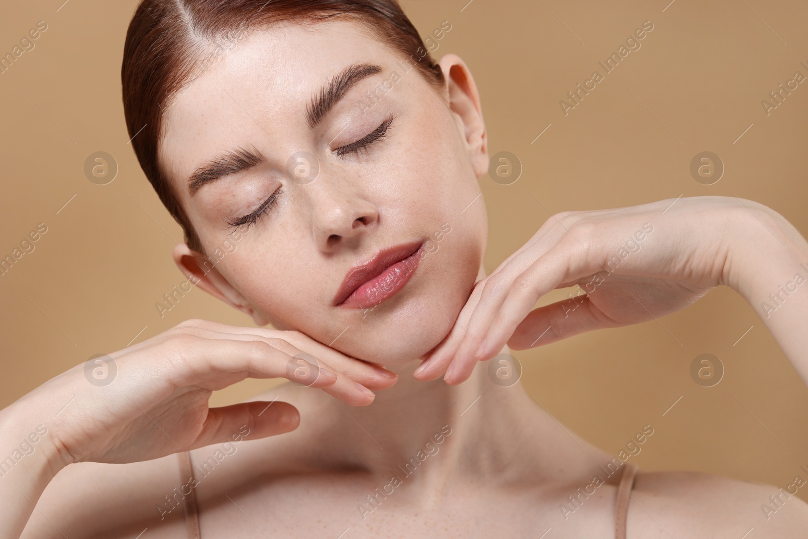 Photo of Portrait of beautiful woman on beige background, closeup