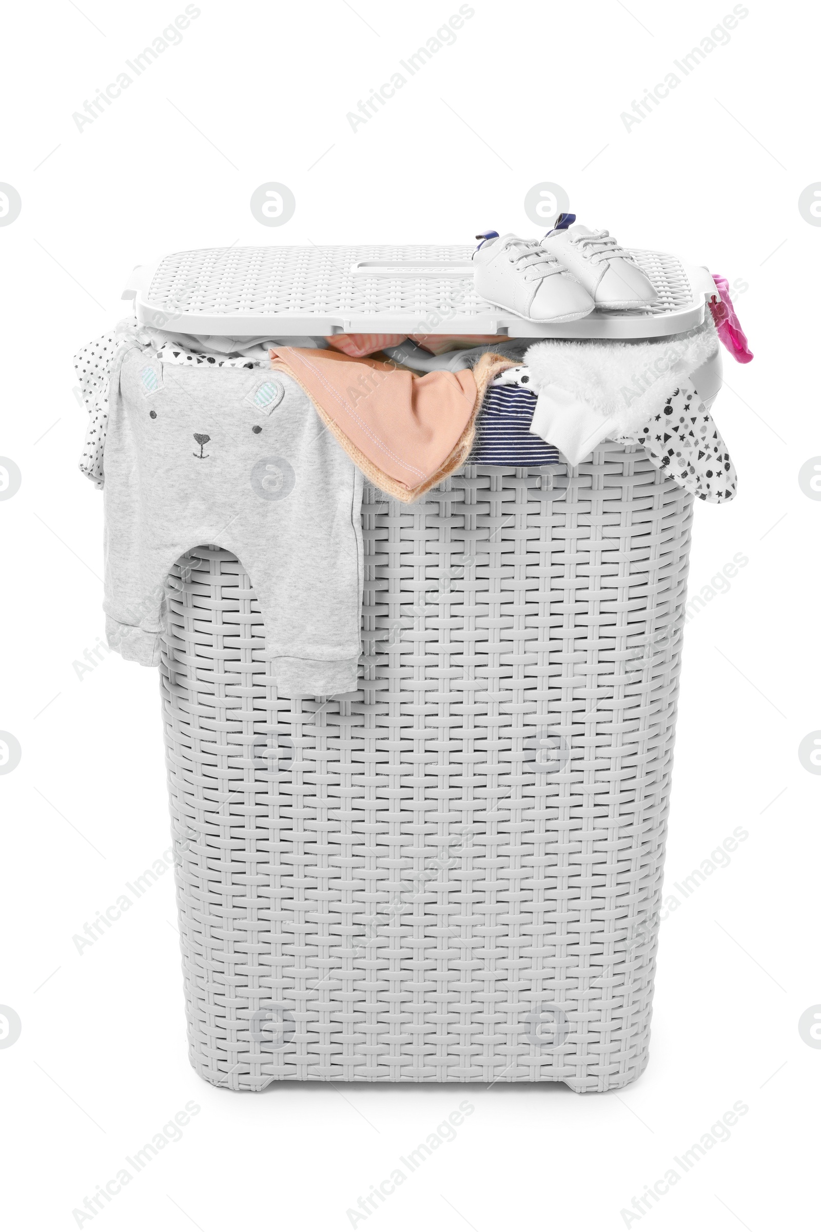 Photo of Laundry basket with baby clothes isolated on white