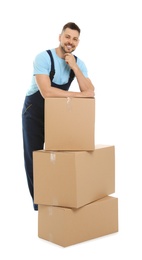 Portrait of moving service employee with cardboard boxes on white background