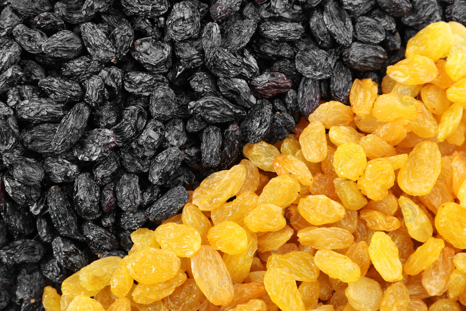 Photo of Different raisins as background, top view. Healthy dried fruit