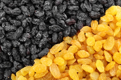 Photo of Different raisins as background, top view. Healthy dried fruit