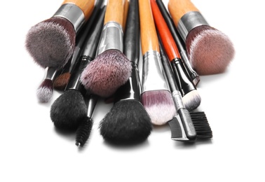 Photo of Makeup brushes of professional artist on white background