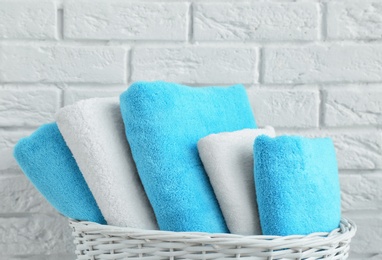 Photo of Wicker basket with clean towels in bathroom