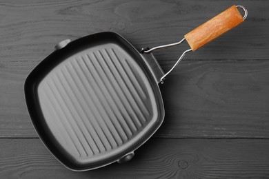 Photo of One frying pan on grey wooden table, top view