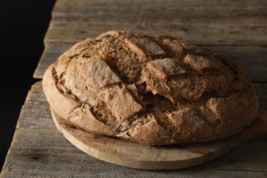 Photo of Freshly baked sourdough bread on wooden table