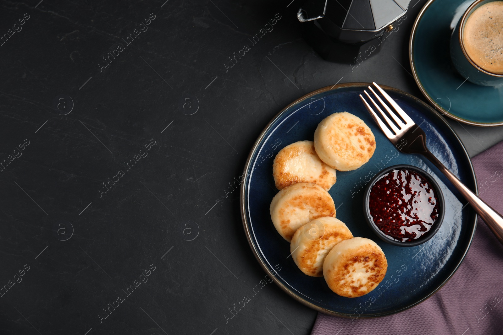 Photo of Delicious cottage cheese pancakes with jam on black table, flat lay. Space for text